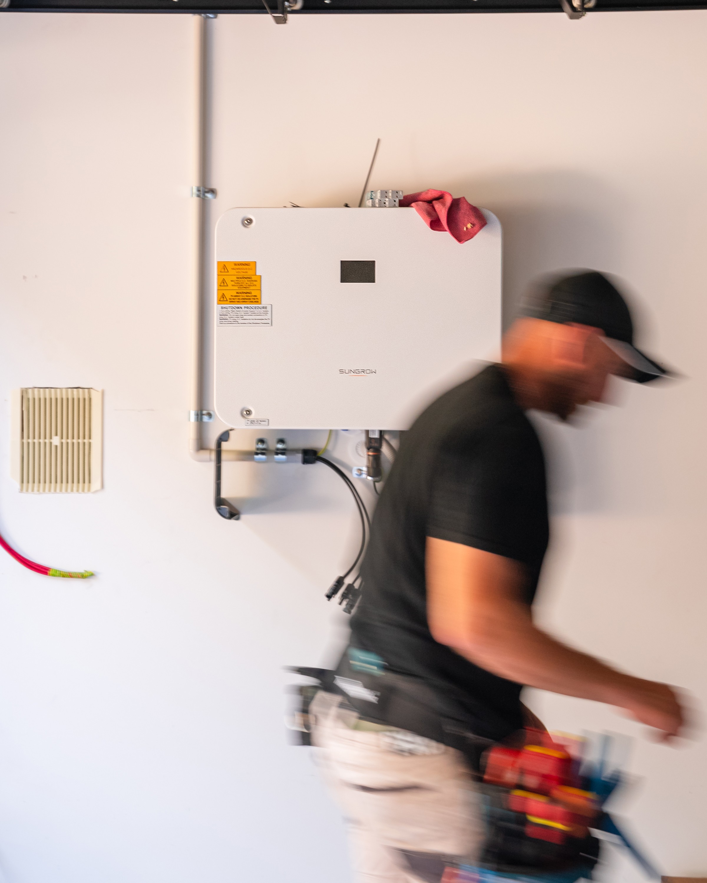 Vivid electrician working on an inverter installation